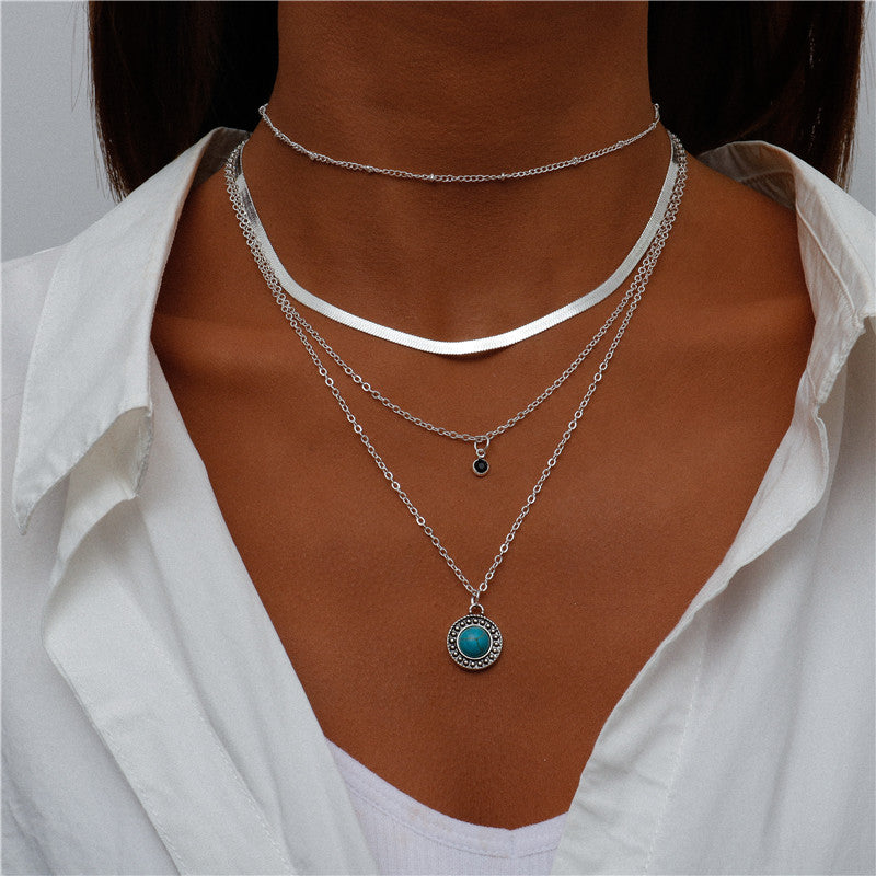multi-layered silver necklace with turquoise pendant